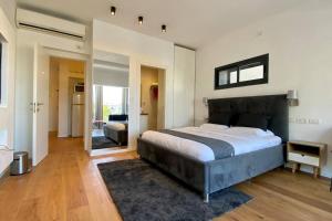 a bedroom with a large bed in a room at The Old North and the Sea Luxury suite in Tel Aviv