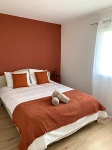 a bedroom with a bed with a stuffed animal on it at Charmante Villa in Châtellerault