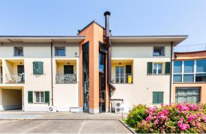 un edificio de apartamentos con flores delante en Lakeside View Colico, en Colico