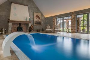 a large room with a swimming pool in a house at 7 STODOŁA - Hotel butikowy in Osiek