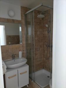 a bathroom with a sink and a shower at Le 1 St Yves Studios in Tréguier