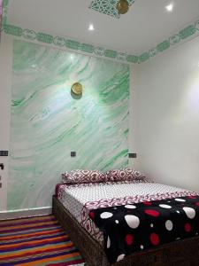 a bedroom with a large painting on the wall at For You Riad Marrakech in Marrakesh +35 photos