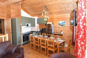 a dining room and kitchen with a table and chairs at Chalet C4 Les Marmottes in Valmeinier