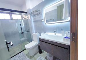 a bathroom with a sink and a toilet and a shower at Rose Manor - Cozy Luxurious 2 Bedroom Apartment in Kilimani Nairobi in Nairobi +21 photos