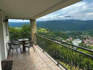 a balcony with a table and chairs and a view at Villa Ostrovica in Bihać +11 photos
