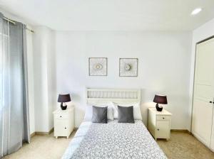 1 dormitorio con 1 cama y 2 mesitas de noche con lámparas en ApartSur®, en Bormujos