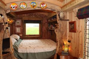 a bedroom in a tree house with a bed in it at Cushieston’s Shepherd’s Hut in Meikle Wartle