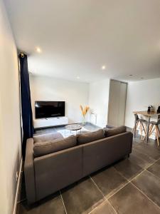 ein Wohnzimmer mit Sofa und Tisch in der Unterkunft Charmant Appartement au Cœur de Blois in Blois + 5 Fotos