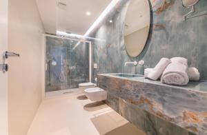 a bathroom with a sink and a mirror at Palazzo Martinelli in Sorrento +109 photos