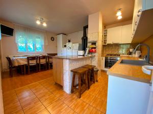 a large kitchen with a island in the middle at Casa Popa in Cârțișoara