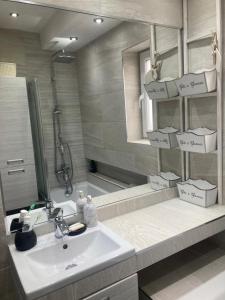 a bathroom with a sink and some boxes on a shelf at Peasholm Luxury House in Scarborough