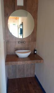 a bathroom with a sink and a mirror at Raíces in Puerto Pirámides