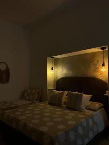 a bedroom with a bed with a head board and lights at La Esperanza De Santa Rita in Bari