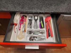 a drawer filled with utensils on top of a counter at къща за гости Градина in Aheloy