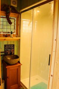 a bathroom with a shower and a sink at Cushieston’s Shepherd’s Hut in Meikle Wartle