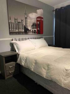 a bedroom with a bed and a red phone booth at Two bed flat stylishly furnished in Purfleet