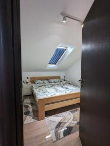 a bedroom with a bed and a skylight at Silver Jordan in Ostrovo