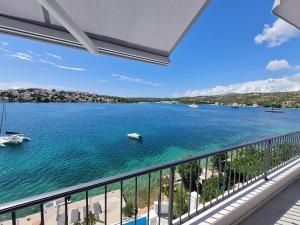 a balcony with a view of a body of water at Villa LUX Apartments in Rogoznica