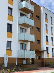 an apartment building with balconies on it at Apartamenty Wieliszew in Wieliszew