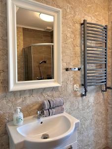 a bathroom with a white sink and a mirror at Apartamenty Golf Dyndeby in Neksø