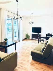a living room with a couch and a table and a piano at Apartament przy Rynku in Poznań