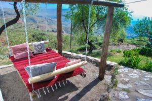 a hammock with a baseball bat and a bat swing at Cortijo Los Maximos in Turón