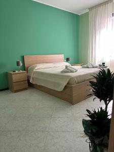 een slaapkamer met een bed en een blauwe muur bij Claire Rose B&B in Matera