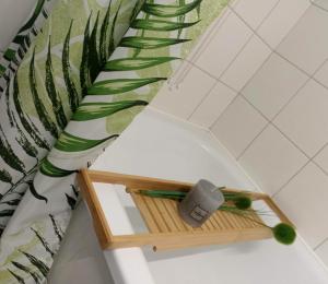 a shelf in a bathroom with a plant at Chill Studio in Łódź