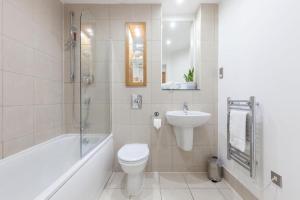 a white bathroom with a toilet and a sink at Exquisite One Bedroom Apartment in the Heart of Sheffield City Centre in Sheffield