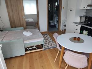 a small room with a table and a table and chairs at Veranda in Saborsko
