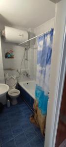 a bathroom with a tub and a toilet and a sink at SEA VIEW FLORA in Burgas City