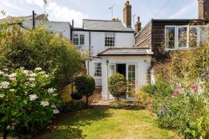 a cottage with a garden in front of it at The Kept Cottage in Hassocks