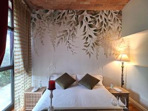 - une chambre avec un lit et un mur orné de fleurs dans l'établissement YOUR HOME in FLORENCE - Private swimming pool and Turkish bath, à Florence