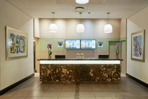 a lobby with a reception desk in a building at Protea Hotel by Marriott Cape Town North Wharf in Cape Town