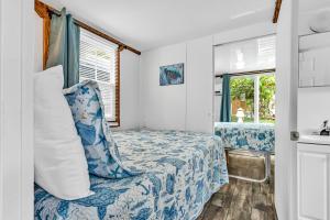a small bedroom with a bed and a window at Treasure Harbor in Islamorada