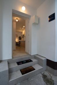 a hallway with stairs leading to a room with a door at VINCENT Studio Apartment in Rijeka