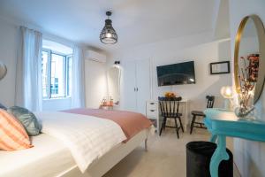 a bedroom with a bed and a desk with a mirror at VINCENT Studio Apartment in Rijeka