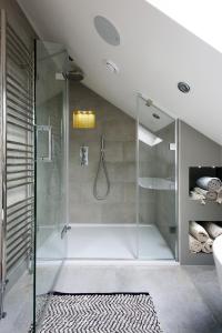 a bathroom with a shower with a glass door at Pet-friendly Luxury Home For Families & Friends in Brighton & Hove