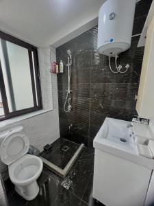 uma casa de banho com um WC e um lavatório em Your Joyful Spot em Shkodër