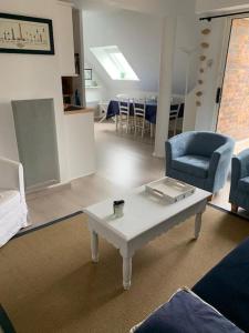 un soggiorno con tavolo e sedie blu di Appart duplex hypercentre 8 pers , petite vue mer a Le Touquet-Paris-Plage