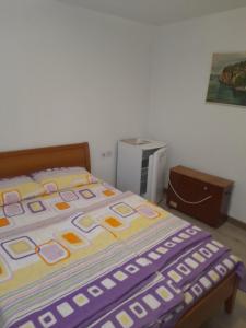 a bed with a colorful blanket on it in a room at Vila Veronika in Ohrid