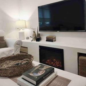 sala de estar con chimenea y TV de pantalla plana en Apartamento en centro de Oviedo, en Oviedo