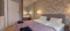 ein Schlafzimmer mit einem großen Bett mit einer Wand in der Unterkunft Kameralny Apartament nieopodal Gdyni parking NEW in Pogórze