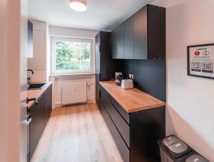 a small kitchen with a counter and a window at unique Komfortsuite - Göppingen in Göppingen