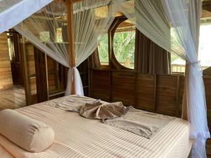 a bedroom with a bed with a canopy at Treehouse in Ella