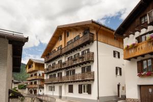 a building with balconies on the side of it at SnowLake Suite & Apartment in Alleghe