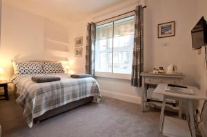 a bedroom with a bed and a window at The Owls in Builth Wells