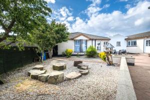 a backyard with a fire pit and a house at Port Tara Holiday Home in Portballintrae