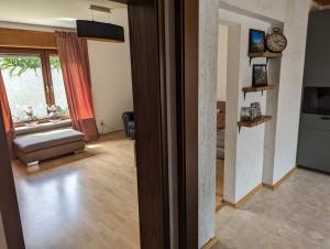 a living room with a couch and a window at Heufelsen Ferienwohnung in Hinterweidenthal