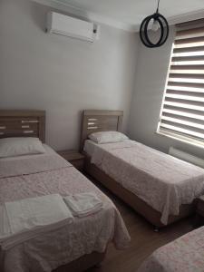 a bedroom with two beds and a window at MEYDANDA 1+1 DAİRE in Trabzon